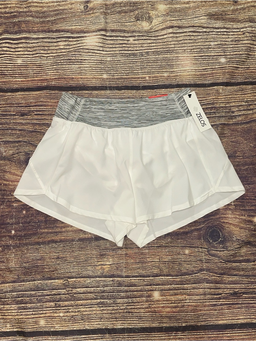 Women’s Zelos shorts in white with a gray heathered waistband. NWT. Small.